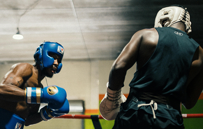 Picture of two boxers leaning in a ring